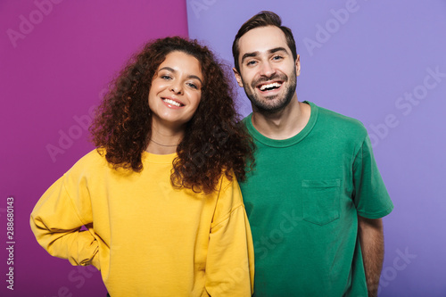 Portrait of beautiful caucasian couple man and woman in colorful clothing smiling together at camera © Drobot Dean