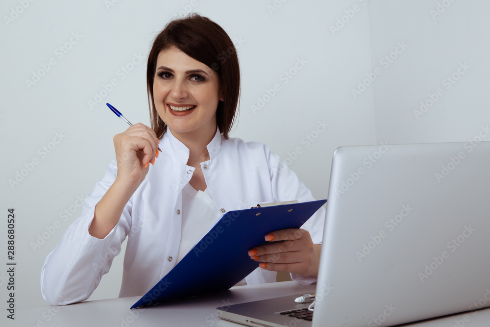 Woman dentist sitting at the table in office with dental staff isolated Woman dentist sitting at the table in office with dental staff isolated