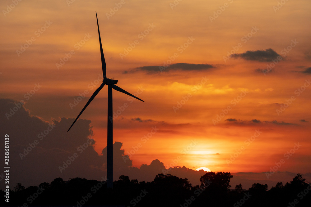 silhouette of wind turbine located on a ridge with wind blowing all the time. Making it able to effectively produce renewable electricity, which is another clean energy. silhouette of wind turbine located on a ridge with wind blowing all the time. Making it able to effectively produce renewable electricity, which is another clean energy.