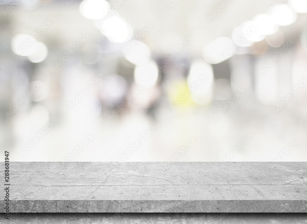 Empty stone table top on gray blur abstract background from inside shopping mall,Used for display or montage your products Empty stone table top on gray blur abstract background from inside shopping mall,Used for display or montage your products