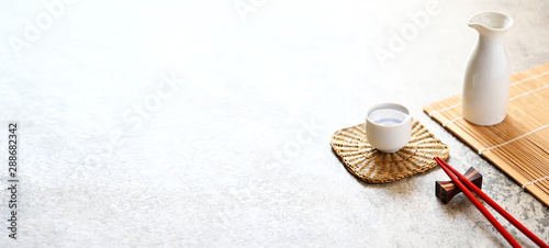 Red chopsticks and japanese sake oriental drink style on the table,copy space