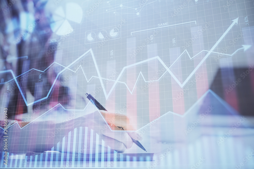 A woman hands writing information about stock market in notepad. Forex chart holograms in front. Concept of research. Double exposure A woman hands writing information about stock market in notepad. Forex chart holograms in front. Concept of research. Double exposure