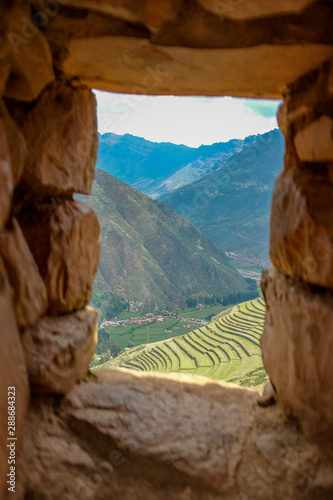 Agriculture Terraces Trough the Window of Ancient Incan Fort in The Ruins of Pisac City in Sacred Valley, Cuzco, Peru