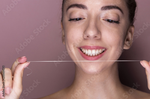 Smiley young girl ready to floss