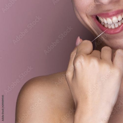 Close-up beautiful woman flossing