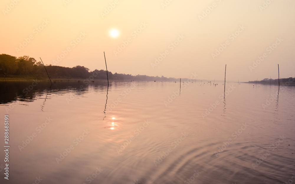 Beautiful Sunset scene On Lake water surface natural composition. Sunset over lake Beautiful Sunset scene On Lake water surface natural composition. Sunset over lake