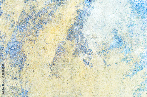 Abstract background. Damaged wall with traces of destruction. Rough and uneven surface of an old building.