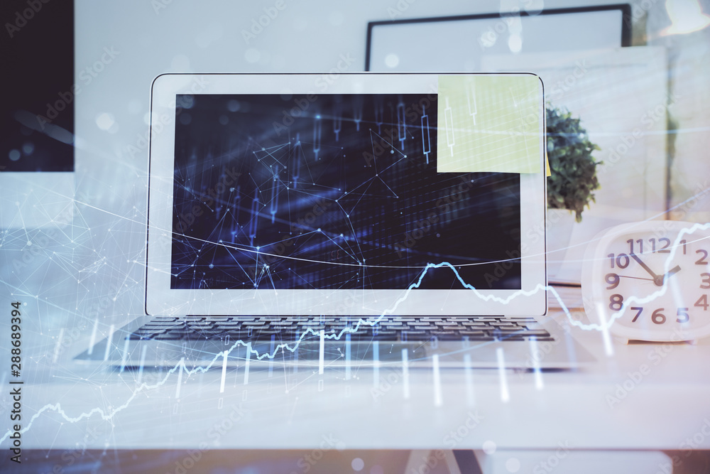 Fototapeta premium Stock market graph on background with desk and personal computer. Double exposure. Concept of financial analysis.