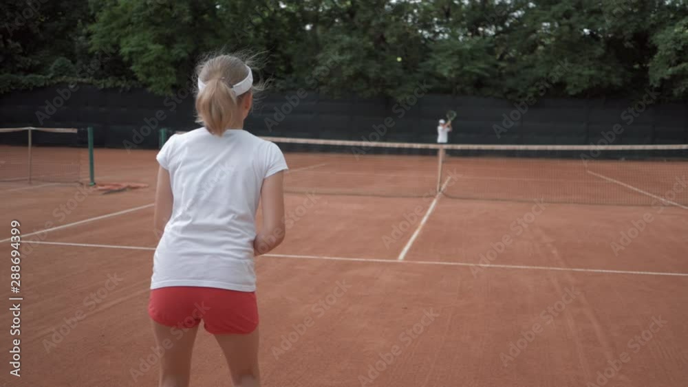 tennis game, sports player adolescent girl with contestant hitting racket on ball pass through net to each other at court during championship tennis game, sports player adolescent girl with contestant hitting racket on ball pass through net to each other at court during championship