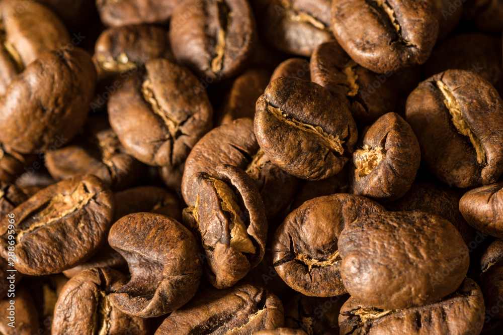 Macro close up of coffee beans on a black background