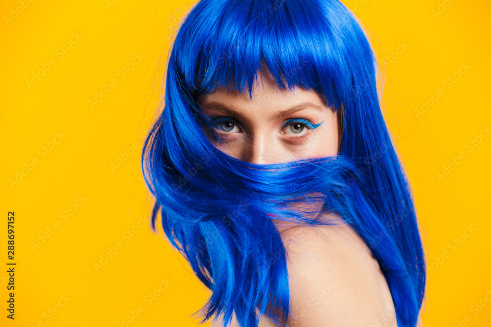 Portrait closeup of seductive nice woman wearing blue wig looking and poising at camera - obrazy, fototapety, plakaty 