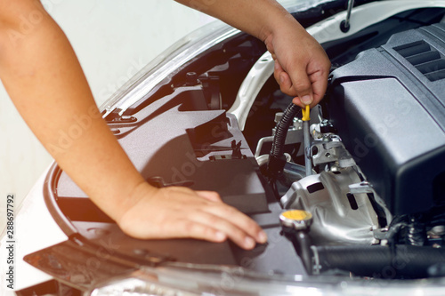 Closeup hand mechanic service car check engine oil