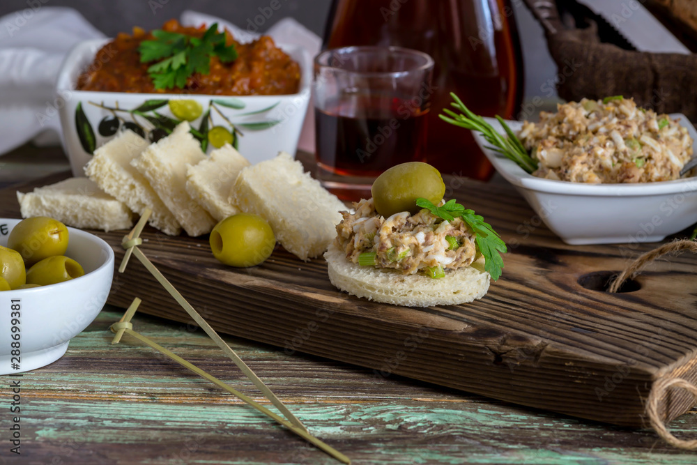 Varied, fresh, tasty snacks and aperitif on wooden table close-up Varied, fresh, tasty snacks and aperitif on wooden table close-up