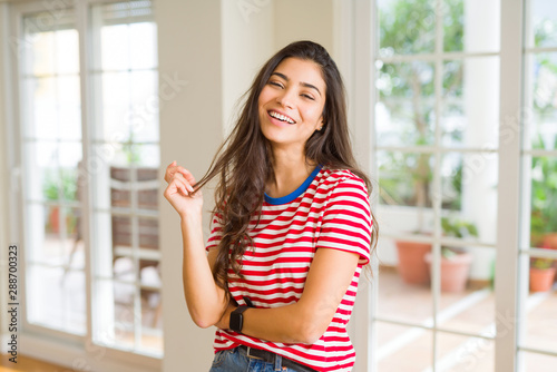 Beautiful brunette woman smiling cheerful, looking happy and positive