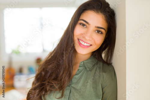 Beautiful brunette woman smiling cheerful, looking happy and positive