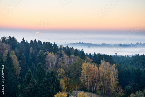 Morning landspace with sun rays. Beautiful landscape with forest and fog.Lithuanian landscape.