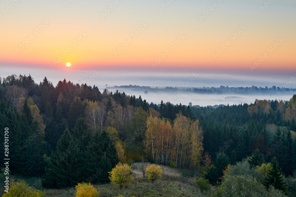 Morning landspace with sun rays. Beautiful landscape with forest and fog.Lithuanian landscape.