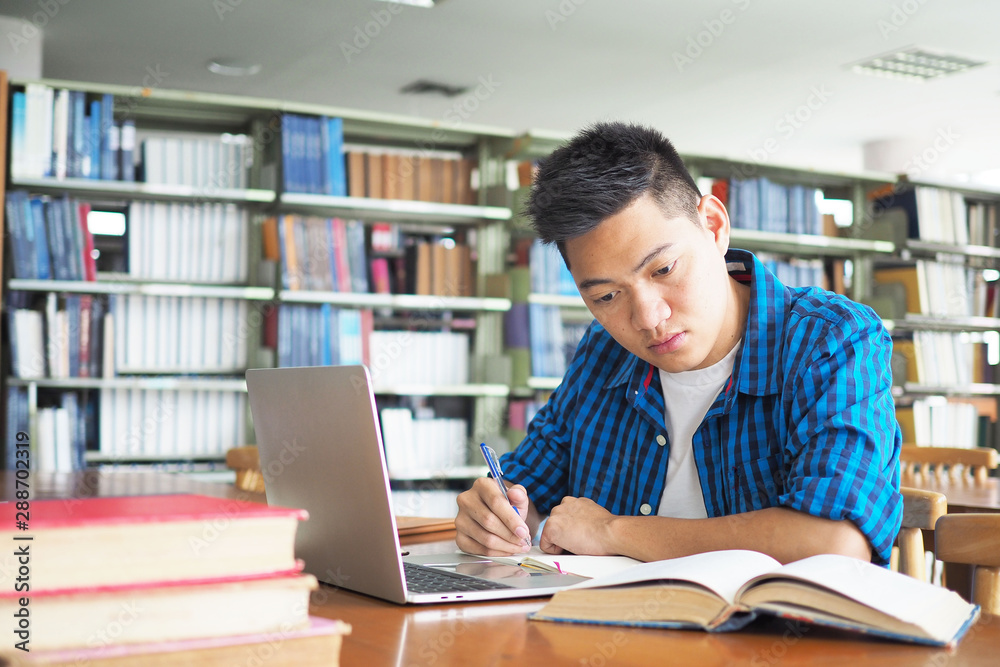 Men use laptops and learn online in the school library. It is a modern education. Men use laptops and learn online in the school library. It is a modern education.