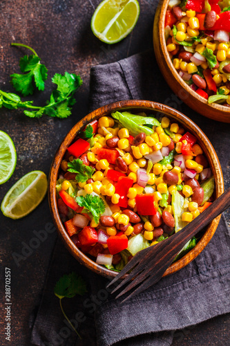 Traditional corn bean mexican salad in a wooden bowl. Mexican food concept.