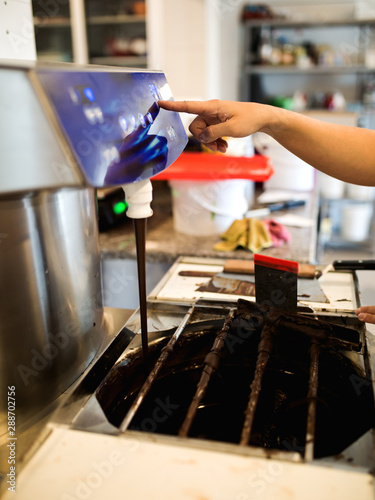 Young woman melting chocolate for cake,stock photo