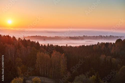 Morning landspace with sun rays. Beautiful landscape with forest and fog.Lithuanian landscape.