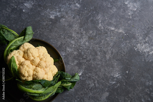 Organic cauliflower on a plate on a dark