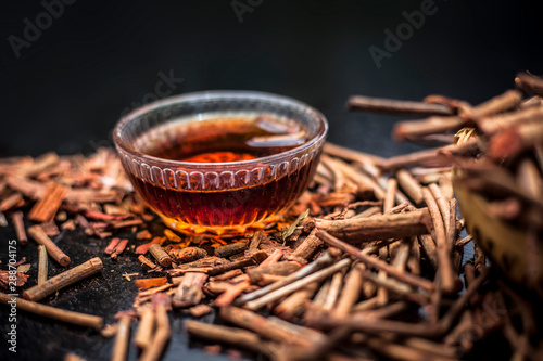 Bunch of Indian madderwort or madder root/manjistha/manzistha/Rubia cordifolia/madder along with some raw organic honey in a glass bowl for making all-purpose cream and used as a mask.Horizontal shot. photo