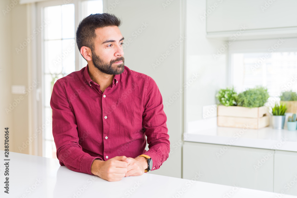 Naklejka premium Handsome hispanic business man looking to side, relax profile pose with natural face with confident smile.