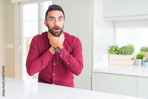 Handsome hispanic business man shouting and suffocate because painful strangle. Health problem. Asphyxiate and suicide concept.