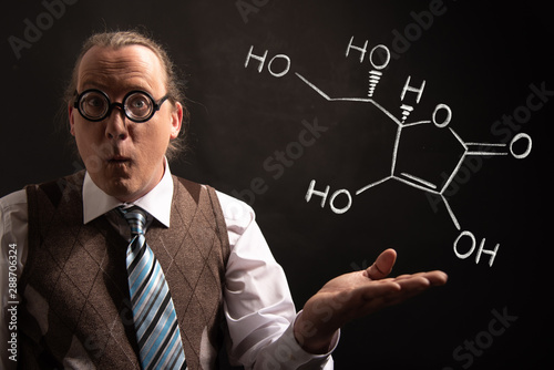 Professor presenting handdrawn chemical formula of Vitamin C