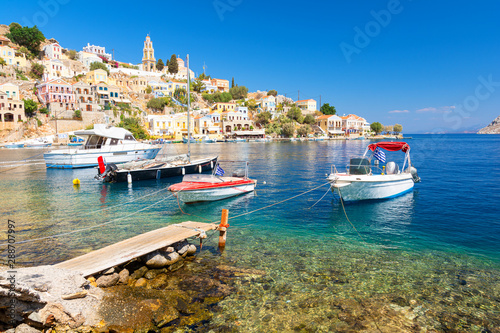 Boats and colorful houses in bay of Symi, symi island, Greece