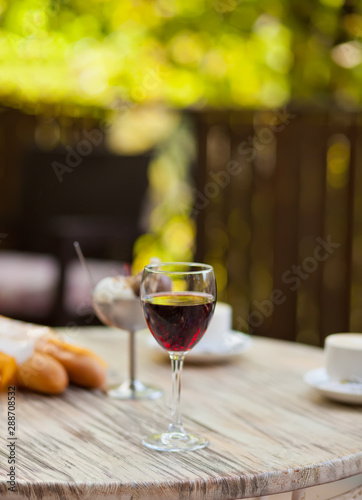Glass with red wine on the table in a outdoor cafe