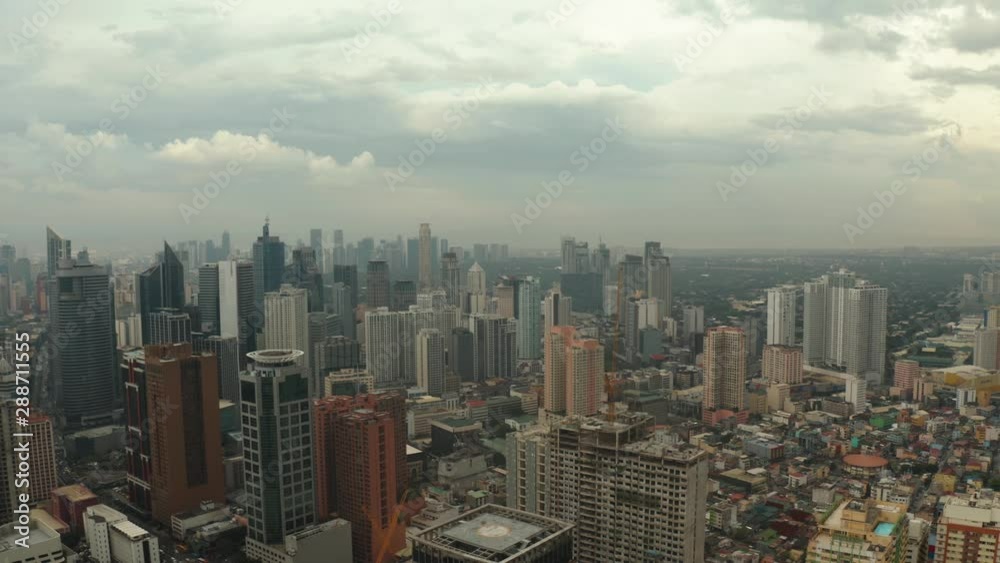 Populous city of Manila, the capital of the Philippines with skyscrapers, streets and buildings. Travel vacation concept. Populous city of Manila, the capital of the Philippines with skyscrapers, streets and buildings. Travel vacation concept.