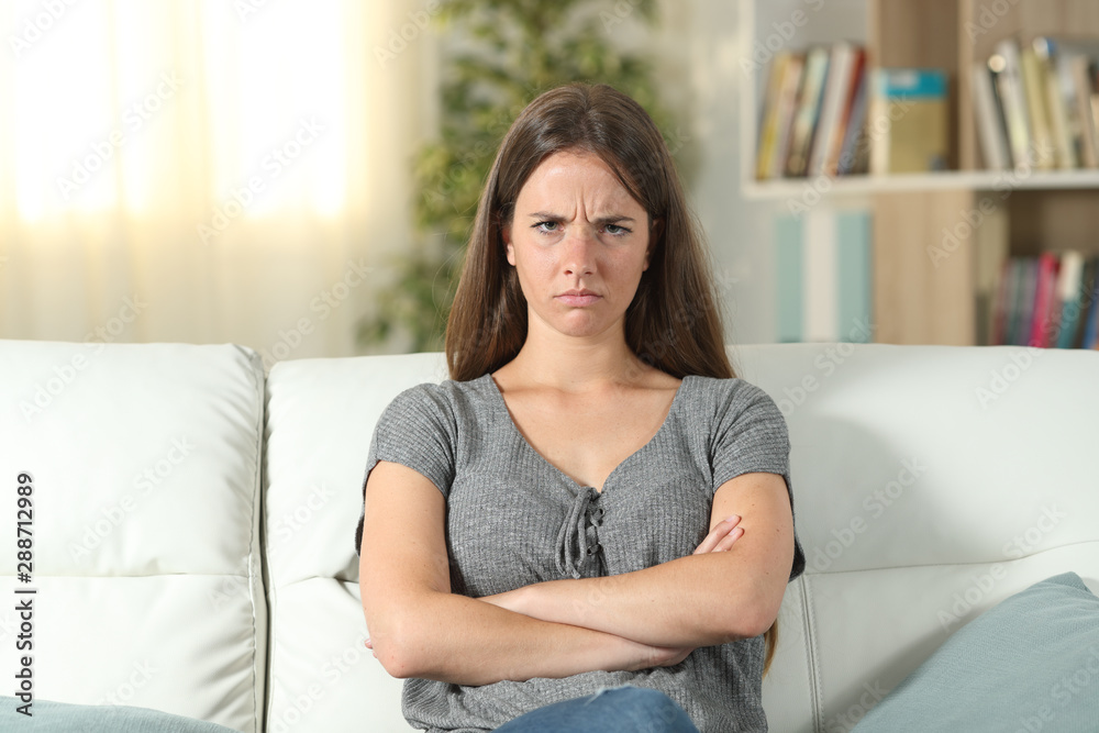 Annoyed woman looking at camera at home Annoyed woman looking at camera at home