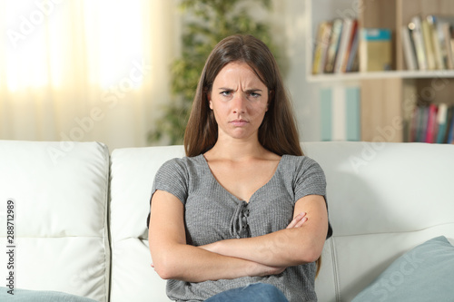 фотографія Annoyed woman looking at camera at home