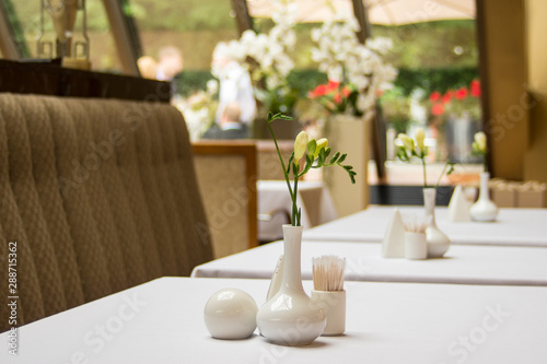 Tables set for meal in modern restaurant