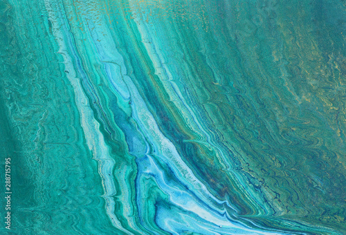 art photography of abstract marbleized effect background. turquoise, emerald green, blue and gold creative colors. Beautiful paint.