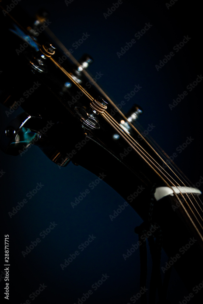 Top of a guitar, strings wrapped around pegs Top of a guitar, strings wrapped around pegs