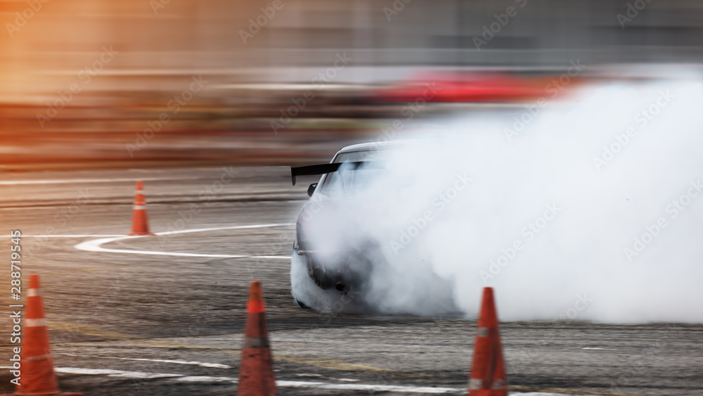 Car drifting, Blurred of image diffusion race drift car with lots of smoke  from burning tires on speed track Stock Photo