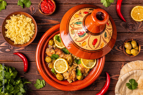 Traditional moroccan tajine of chicken with salted lemons, olives photo