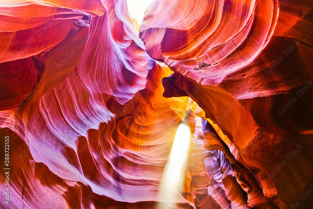 View of Upper Antelope Canyon with sunbeam shined into canyon at noon in early October in Arizona, USA. View of Upper Antelope Canyon with sunbeam shined into canyon at noon in early October in Arizona, USA.