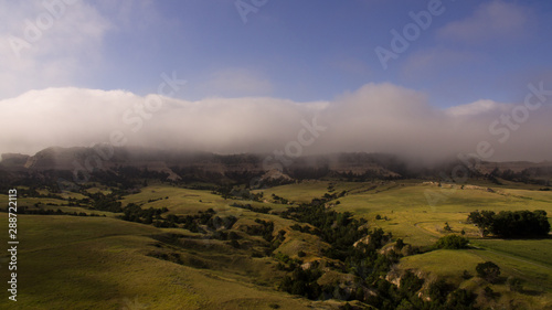 Sunrise over Scottsbluff, Nebraska with low clouds, fog, and blue sky