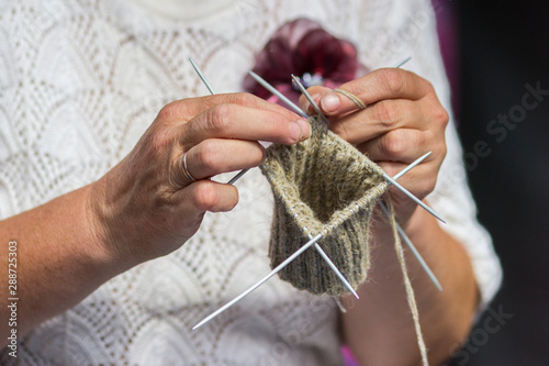 Knitting on knitting. Hands close-up knitting on knitting needles