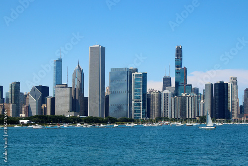 Chicago downtown skyline with Michigan lake.Scenic summer cityscape with lakefront skyscrapers of Chicago with drifting yachts on the Michigan lake harbor. American urban city architecture background. © Maryna