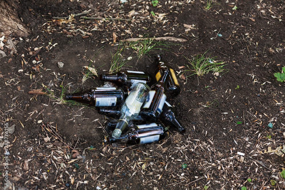 garbage from glass bottles lies on the ground and not in the trash