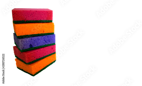 Multi-colored cleaning sponges for washing dishes on a white background isolated. Pile of dish sponges copy space.