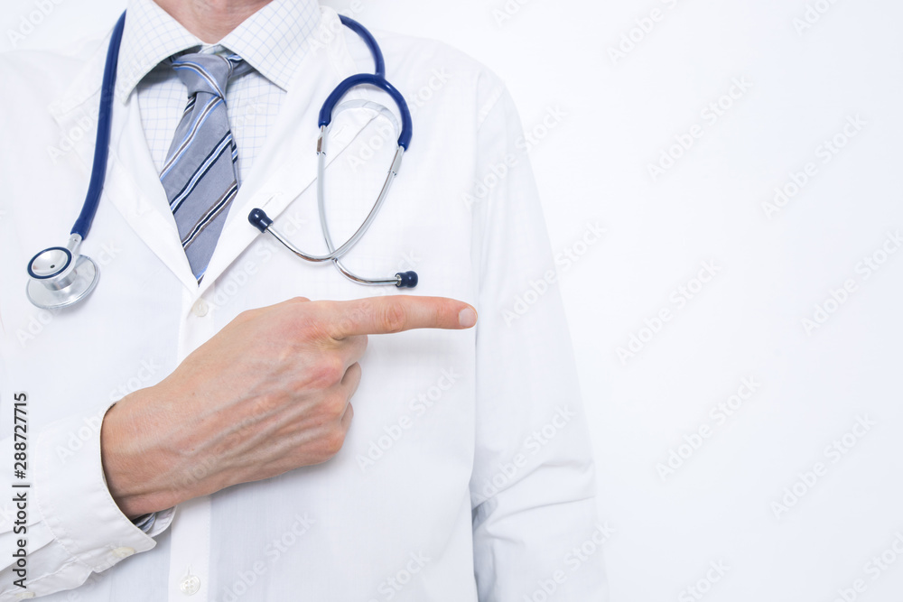 A doctor in a white coat points to copy space. A doctor in a white coat points to copy space.