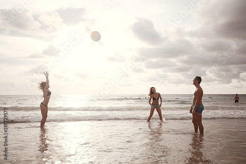 friends play a ball in the water / fun in summer vacation game with a ball in the water