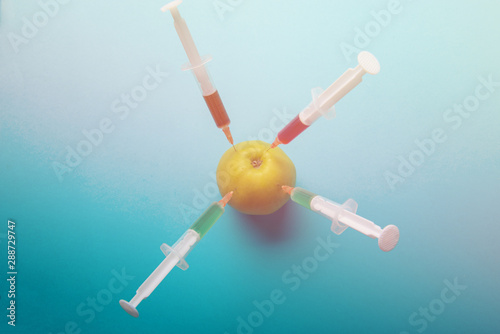 Chemical additives in food or genetically modified fruit concept.