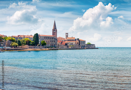 Amazing spring view of old Assumption of Mary church. Sunny morning cityscape in Porec, Croatia, Europe. Traveling concept background.